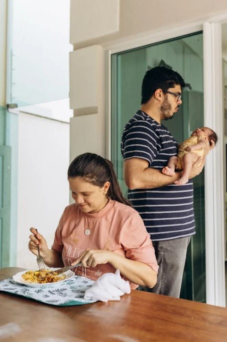 Dad helping care for the baby