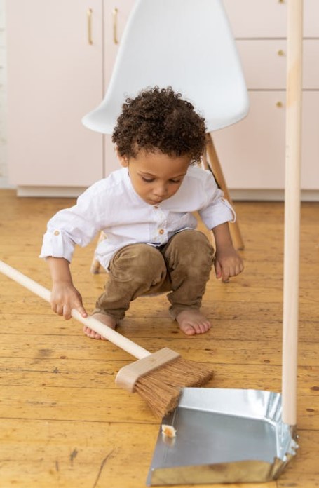 clean up the floor with a broom