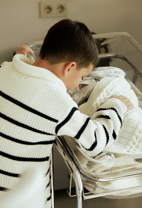 Toddler meeting the newborn at the hospital for the first time